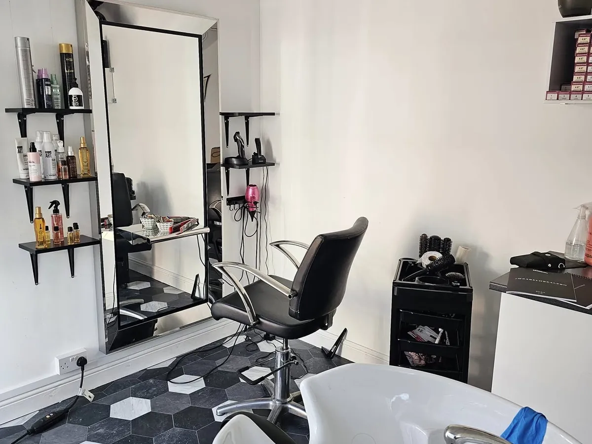 Tanya’s studio, with a styling chair, large mirror, product shelves and a wash basin